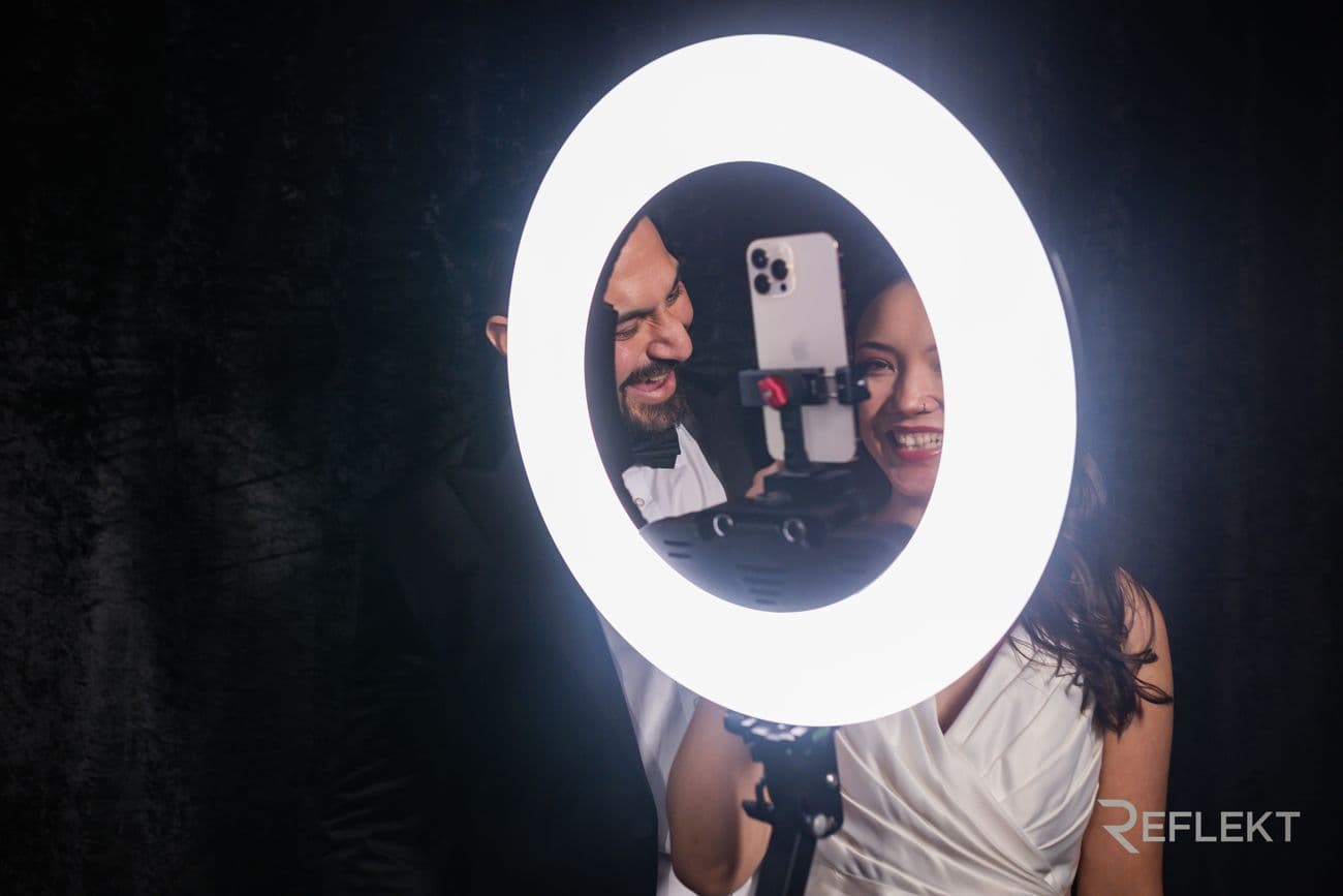 Guests framed through the ring light of a video booth