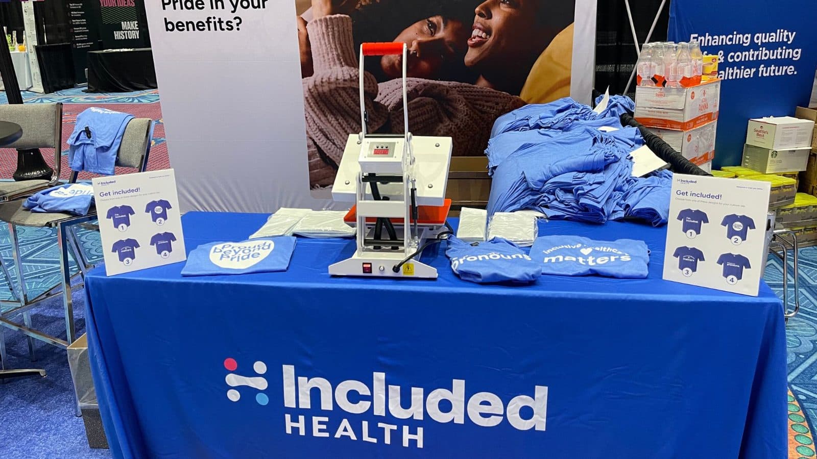 Express heat press station with folded custom shirts at a brand's conference booth