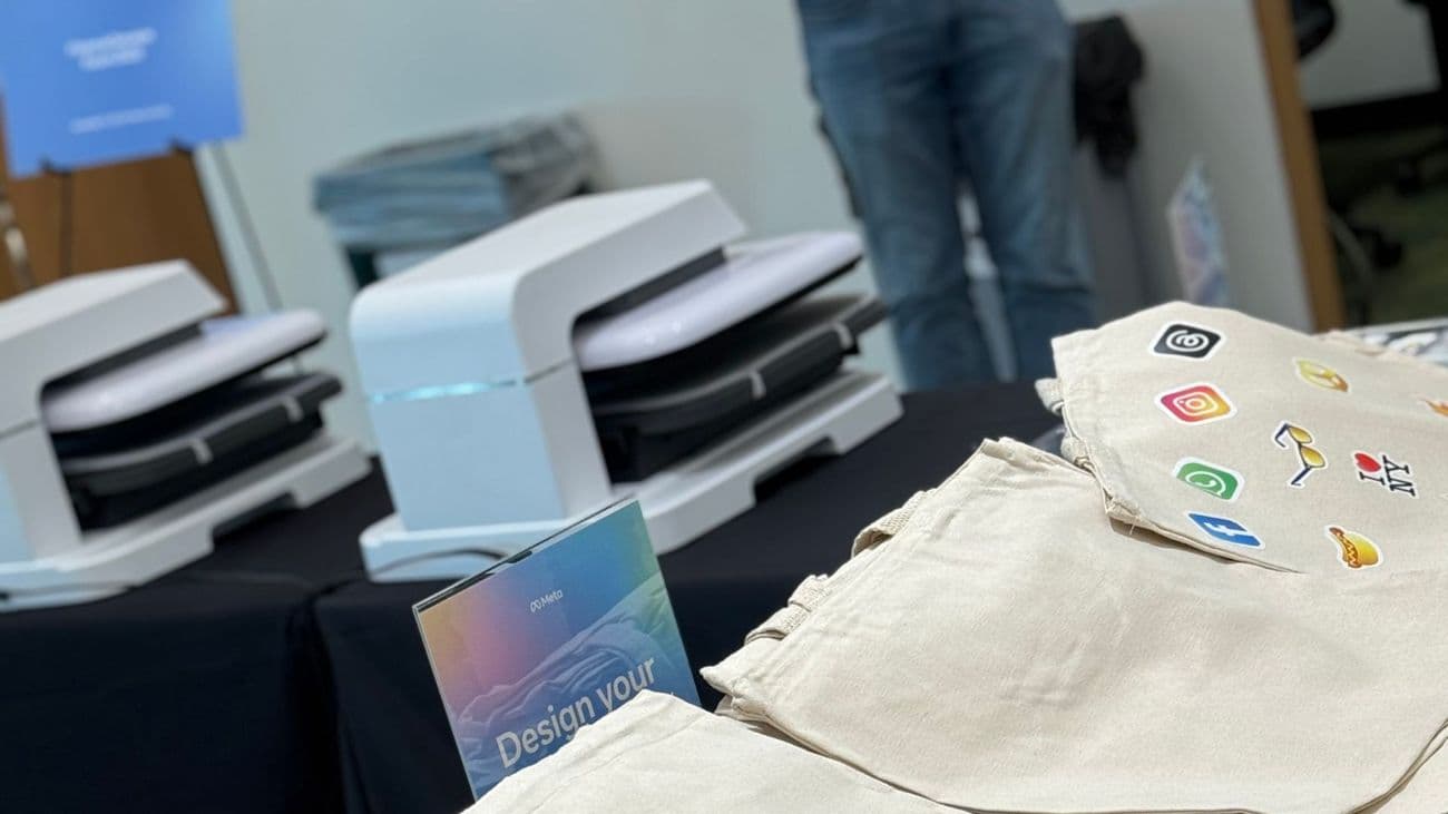 Live tote bag printing table with two heat presses ready for guests