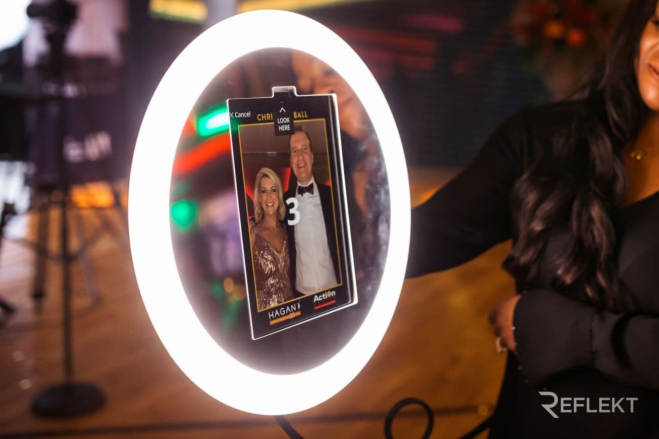 Guests viewing their photo on a roaming photo booth at a gala