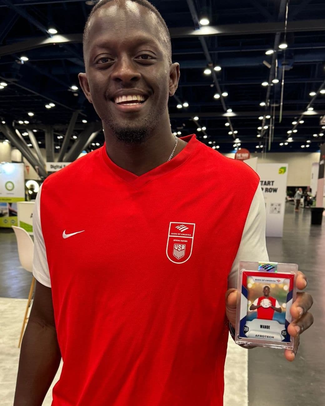 Trade show attendee holding his personalized trading card from the photo booth